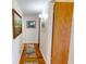 Hallway with wood floors and neutral walls decorated with an assortment of pictures at 12485 2Nd E St # C103, Treasure Island, FL 33706