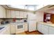 Well-lit kitchen with white appliances, countertops, and cabinetry at 12485 2Nd E St # C103, Treasure Island, FL 33706