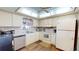 Bright kitchen with white cabinetry, modern appliances, and ample countertop space at 12485 2Nd E St # C103, Treasure Island, FL 33706