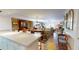 Bright open-concept living and dining area with hardwood floors and comfortable furniture at 12485 2Nd E St # C103, Treasure Island, FL 33706