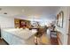 Open-concept living and dining area with hardwood floors, fireplace, and natural light at 12485 2Nd E St # C103, Treasure Island, FL 33706