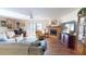 Open living room featuring hard floors, a fireplace, and a sliding glass door to the outside at 12485 2Nd E St # C103, Treasure Island, FL 33706