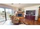 Bright living room featuring hard floors, a corner fireplace, and a sliding glass door to the outside at 12485 2Nd E St # C103, Treasure Island, FL 33706