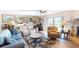 Spacious living room featuring hard floors, a ceiling fan, and access to the outside at 12485 2Nd E St # C103, Treasure Island, FL 33706