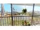 Screened patio with chairs and plants, offering a view of the surrounding neighborhood at 12485 2Nd E St # C103, Treasure Island, FL 33706