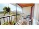 Screened patio with chairs and plants, offering a view of the surrounding neighborhood at 12485 2Nd E St # C103, Treasure Island, FL 33706