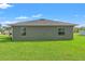 Exterior view of a home with lush green lawn and natural light at 13193 Paxton Ave, Weeki Wachee, FL 34614