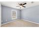 Cozy bedroom featuring a ceiling fan and natural light from a window at 13193 Paxton Ave, Weeki Wachee, FL 34614