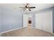 Bedroom with carpet, fan and closet leading to bathroom at 13193 Paxton Ave, Weeki Wachee, FL 34614