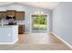 Eat-in kitchen with wood-look tile floors and a sliding glass door to the backyard at 13193 Paxton Ave, Weeki Wachee, FL 34614
