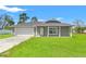 Charming single-story home featuring a well-manicured lawn and attached two-car garage at 13193 Paxton Ave, Weeki Wachee, FL 34614
