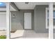 Inviting front entrance features a white door with sidelights and classic white pillars at 13193 Paxton Ave, Weeki Wachee, FL 34614