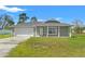 Charming single-story home with a well-manicured lawn and attached two-car garage at 13193 Paxton Ave, Weeki Wachee, FL 34614