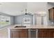 The kitchen features an island with granite countertops and stainless steel appliances at 13193 Paxton Ave, Weeki Wachee, FL 34614