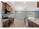 Wide view of the kitchen with stainless steel appliances and granite countertops at 13193 Paxton Ave, Weeki Wachee, FL 34614