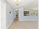 Open-concept living area with wood-look floors leading to carpet and an eat-in kitchen at 13193 Paxton Ave, Weeki Wachee, FL 34614
