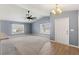 Open living space with large windows, wood-look floors, and carpet, flowing to the kitchen at 13193 Paxton Ave, Weeki Wachee, FL 34614