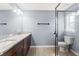 The main bathroom features double sinks, a glass shower and tile flooring at 13193 Paxton Ave, Weeki Wachee, FL 34614