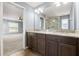 The main bathroom features double sinks, granite countertops and a glass shower at 13193 Paxton Ave, Weeki Wachee, FL 34614