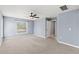 The main bedroom features a window, ceiling fan and neutral walls at 13193 Paxton Ave, Weeki Wachee, FL 34614