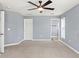 The main bedroom features neutral walls, carpet flooring and a ceiling fan at 13193 Paxton Ave, Weeki Wachee, FL 34614