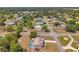 Aerial view showcasing a residential home featuring a screened-in pool in its backyard at 13290 Don Loop, Spring Hill, FL 34609