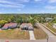 Aerial view of a well-maintained home with a long driveway and mature landscaping at 13290 Don Loop, Spring Hill, FL 34609