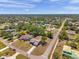 Aerial shot features the home in a serene neighborhood setting with lush trees at 13290 Don Loop, Spring Hill, FL 34609