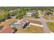 Aerial view of the home with screened pool, lawn, and neighborhood streets at 13290 Don Loop, Spring Hill, FL 34609