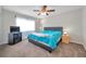 Bedroom with ceiling fan, large window, and adjacent television at 13290 Don Loop, Spring Hill, FL 34609