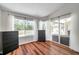 Bright bedroom with wood floors, large windows, and view of the pool at 13290 Don Loop, Spring Hill, FL 34609