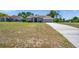Well-manicured front lawn leads up to this one-story house with double door entry and two-car garage at 13290 Don Loop, Spring Hill, FL 34609