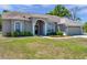 Charming one-story home with manicured lawn, arched entry, and attached two-car garage at 13290 Don Loop, Spring Hill, FL 34609