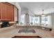 Kitchen features granite countertops and a stainless steel sink with breakfast bar at 13290 Don Loop, Spring Hill, FL 34609