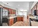 Spacious kitchen with warm cabinets, black appliances, tile floor and a breakfast bar at 13290 Don Loop, Spring Hill, FL 34609