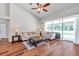 Bright living room with vaulted ceiling, hardwood floors, and sliding glass doors to the pool at 13290 Don Loop, Spring Hill, FL 34609