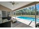 Relaxing screened-in pool patio with comfortable seating, perfect for outdoor enjoyment at 13290 Don Loop, Spring Hill, FL 34609
