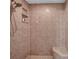 Tiled shower with built-in shelving and a shower bench at 13290 Don Loop, Spring Hill, FL 34609