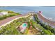 Aerial view of the condos with a community pool, manicured landscaping, and proximity to waterfront amenities at 140 Brent Cir, Oldsmar, FL 34677