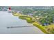 Aerial view of the waterfront condos from across the inlet with waterfront views and a pier at 140 Brent Cir, Oldsmar, FL 34677