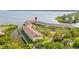 Aerial view of waterfront townhomes showcasing water access, mature trees, and outdoor recreational area at 140 Brent Cir, Oldsmar, FL 34677