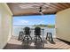 Balcony view with wood ceiling, fan, seating, and view of the water at 140 Brent Cir, Oldsmar, FL 34677