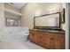 Bright bathroom featuring a double sink vanity with granite countertops and a soaking tub at 140 Brent Cir, Oldsmar, FL 34677