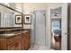 Beautiful bathroom featuring double sink vanity with granite and a glass-enclosed shower at 140 Brent Cir, Oldsmar, FL 34677