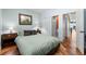 Bright bedroom featuring light blue walls, hardwood floors, and access to the ensuite bathroom at 140 Brent Cir, Oldsmar, FL 34677