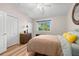 Cozy bedroom with hardwood floors, a ceiling fan, and a sunny window view at 140 Brent Cir, Oldsmar, FL 34677