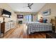 Inviting bedroom with a fireplace, hardwood floors, and private balcony overlooking the water at 140 Brent Cir, Oldsmar, FL 34677