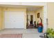 Charming entryway with sidelights, garage access, and decorative planters at 140 Brent Cir, Oldsmar, FL 34677