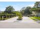 Gated community entrance with well-maintained landscaping and brick pillars, providing security and curb appeal at 140 Brent Cir, Oldsmar, FL 34677