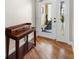 Inviting foyer with gleaming hardwood floors and a charming writing desk at 140 Brent Cir, Oldsmar, FL 34677